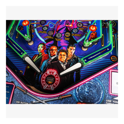 Close-up of a colorful pinball machine with characters and 'Paramount Pictures' logo.
