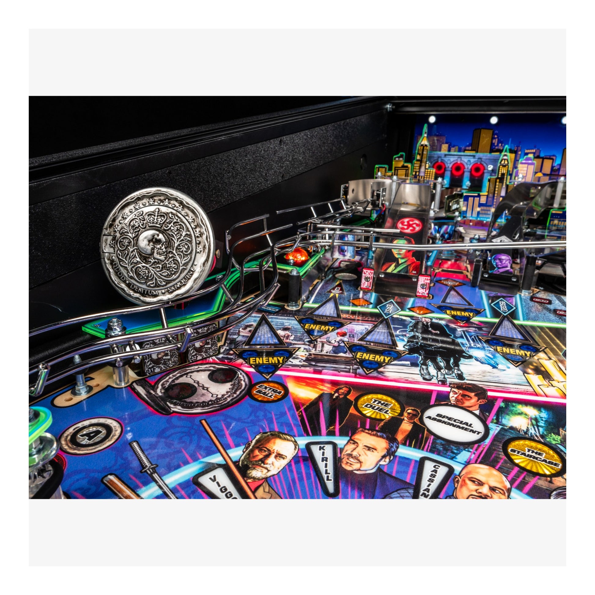 Close-up of a pinball machine with colorful playfield and various components.