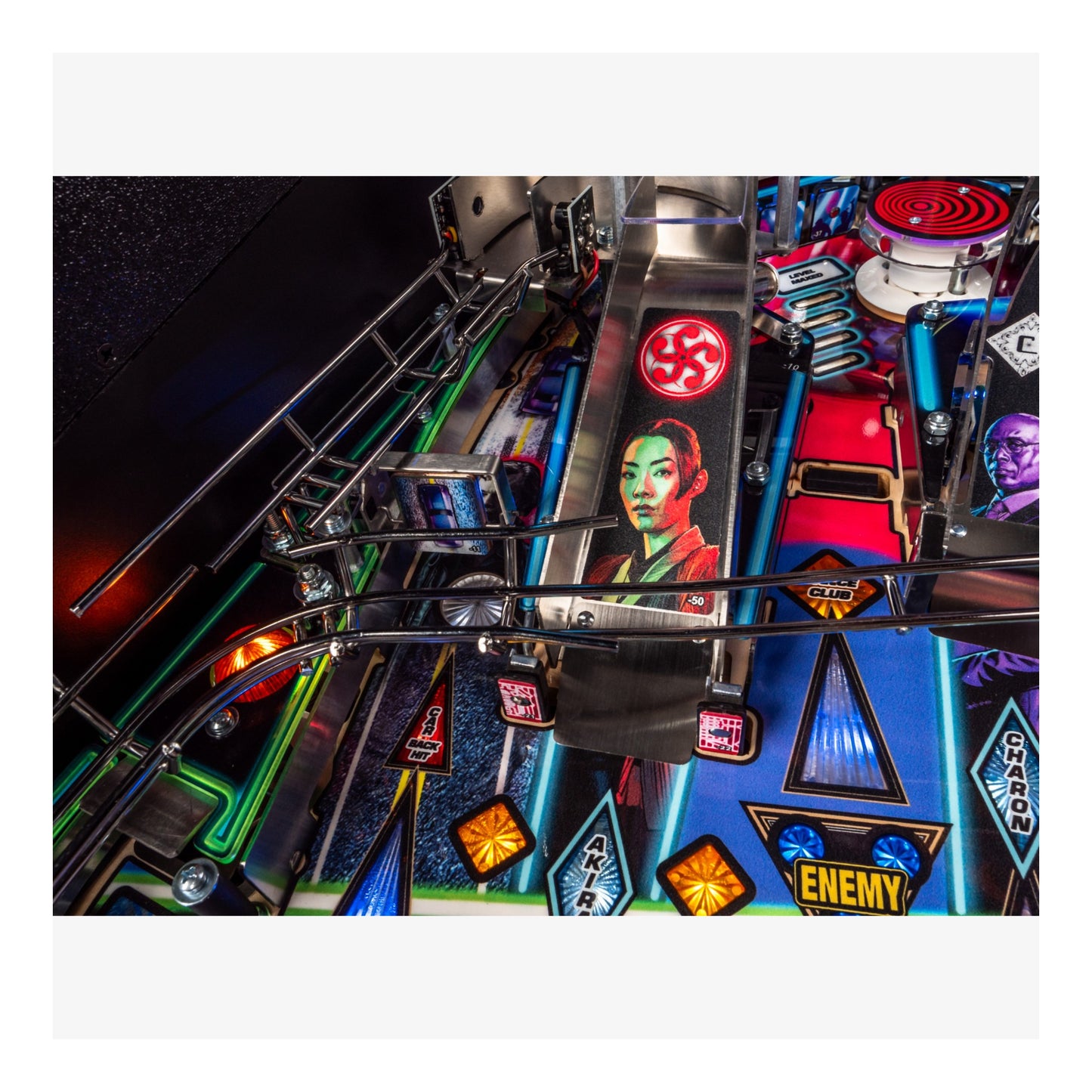 Close-up of a pinball machine with colorful lights and symbols