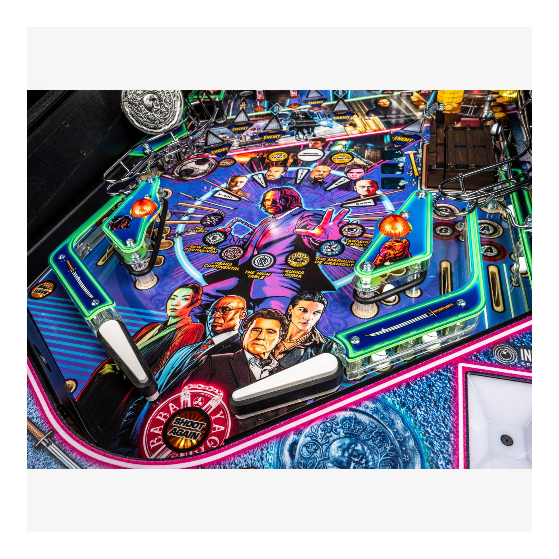 Close-up of a colorful pinball machine with vibrant graphics and neon lights.