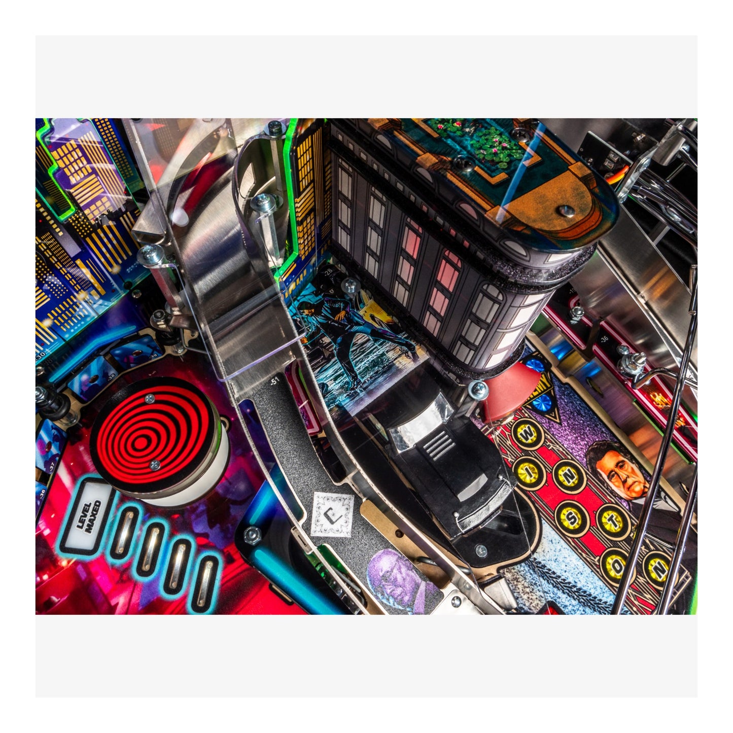 Close-up of a pinball machine with colorful details and a vibrant background.