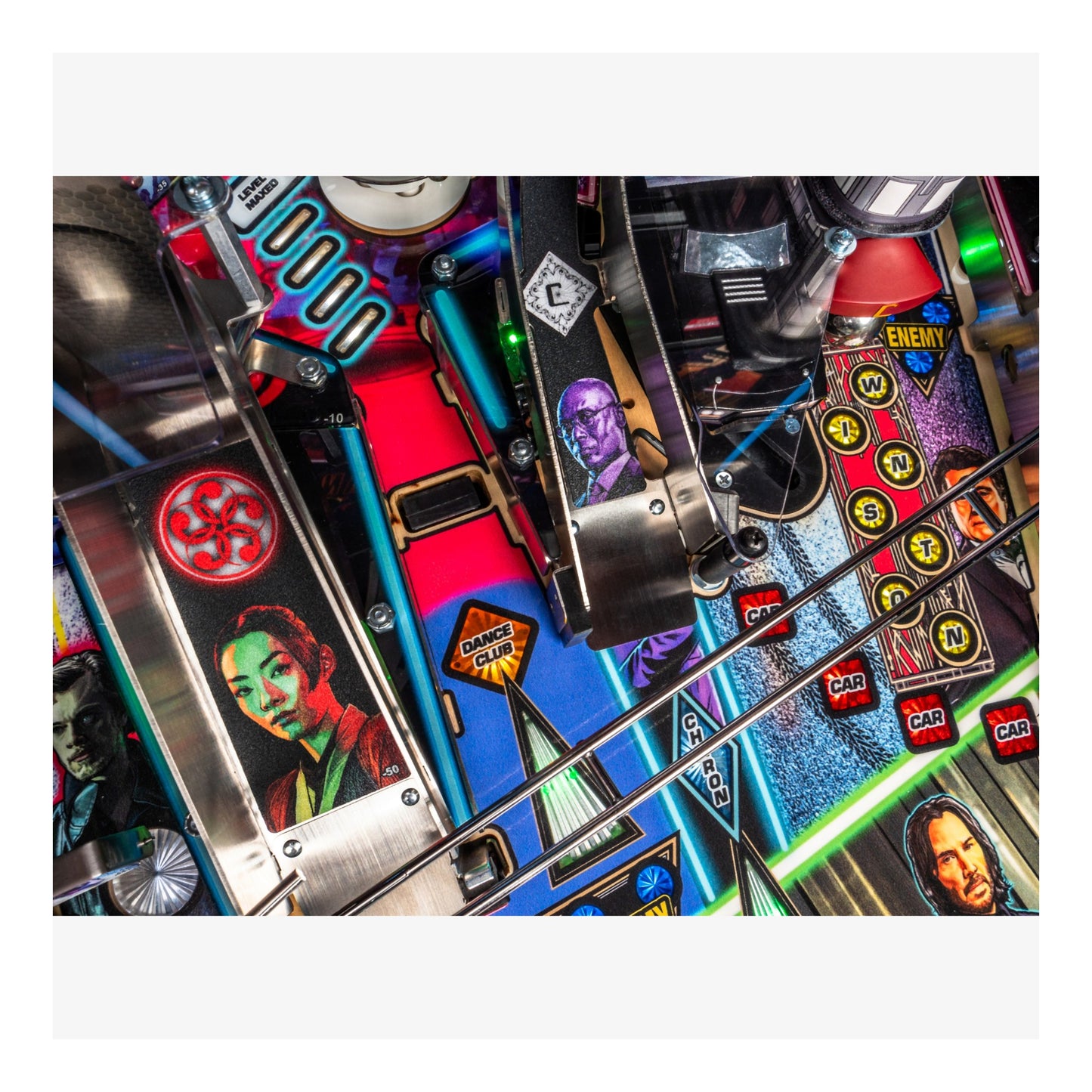 Close-up of a pinball machine with colorful playfield and various components.
