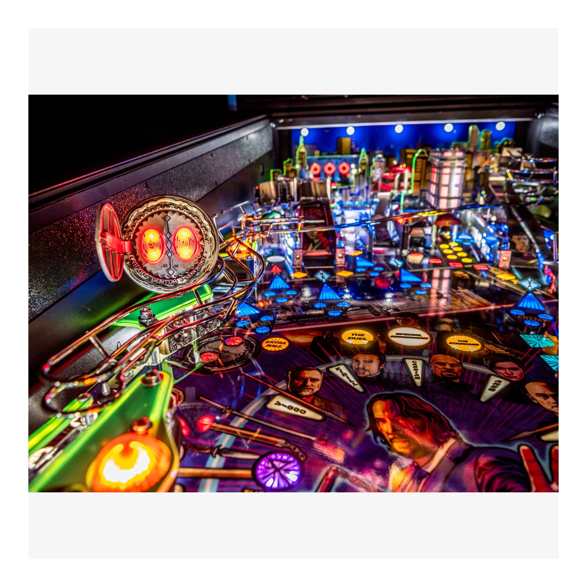Pinball machine with colorful lights and characters on a dark background