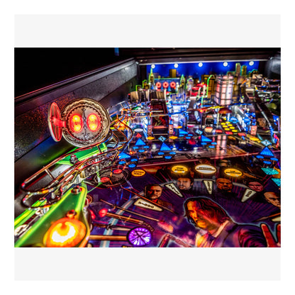 Pinball machine with colorful lights and characters on a dark background