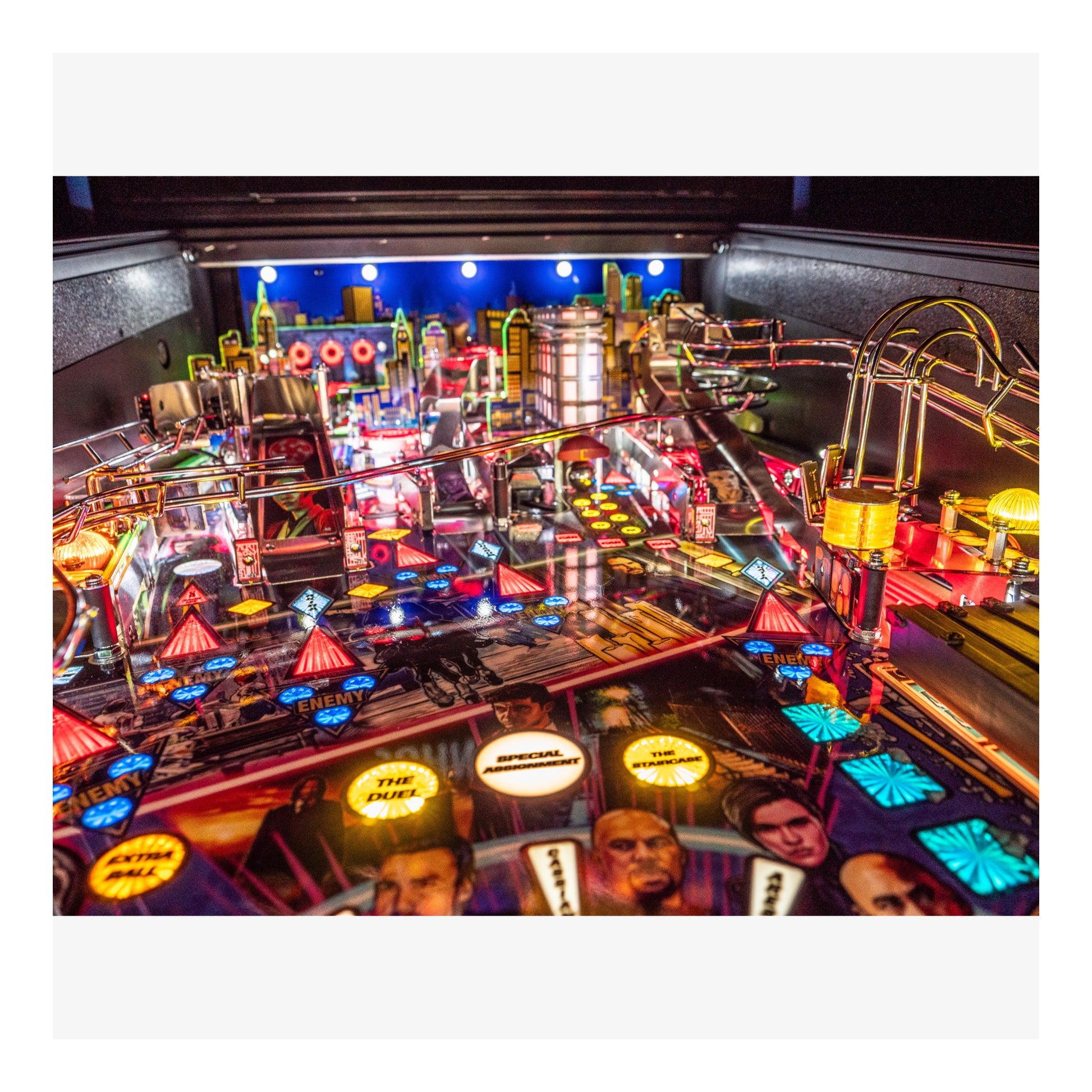 Close-up of a pinball machine with vibrant lights and details