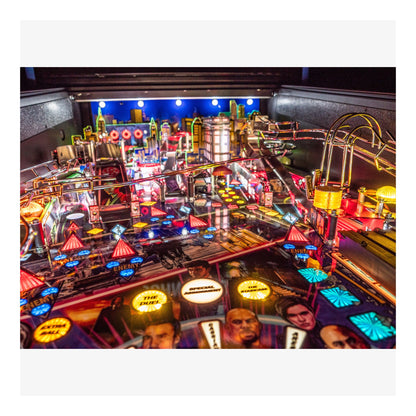 Close-up of a pinball machine with vibrant lights and details
