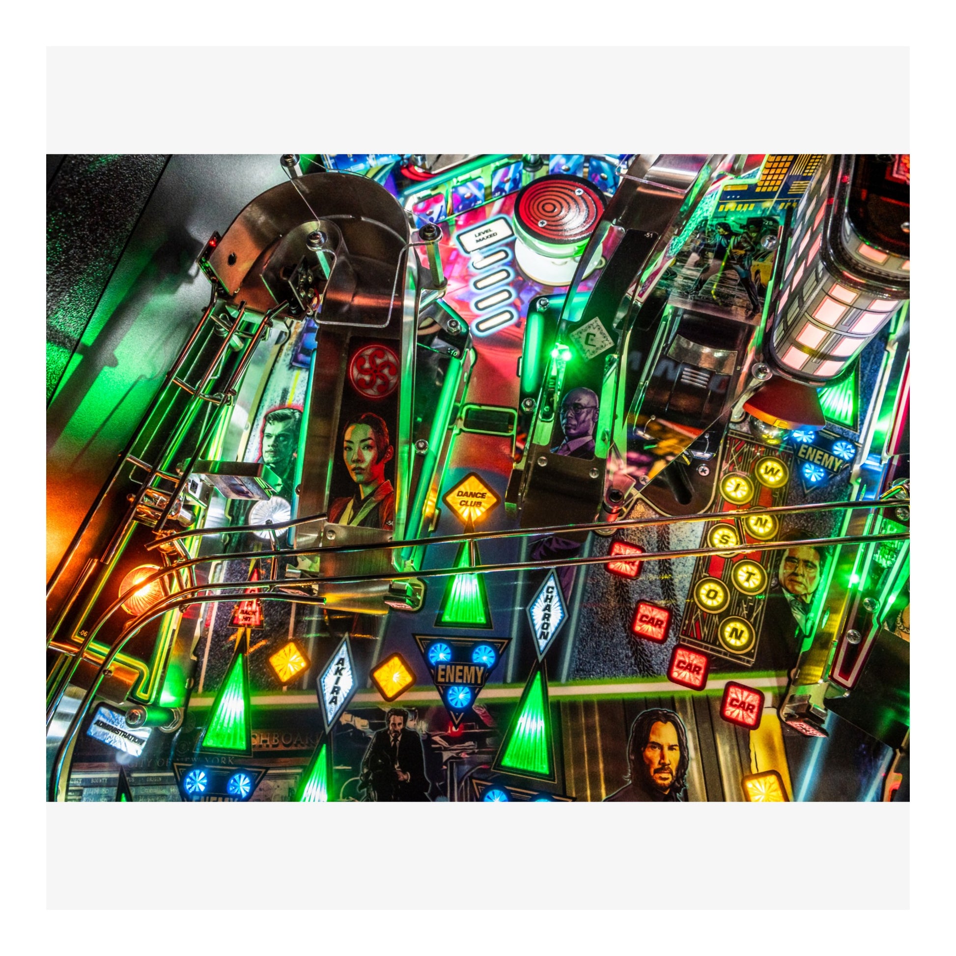 Colorful pinball machine with various lights and characters on a white background