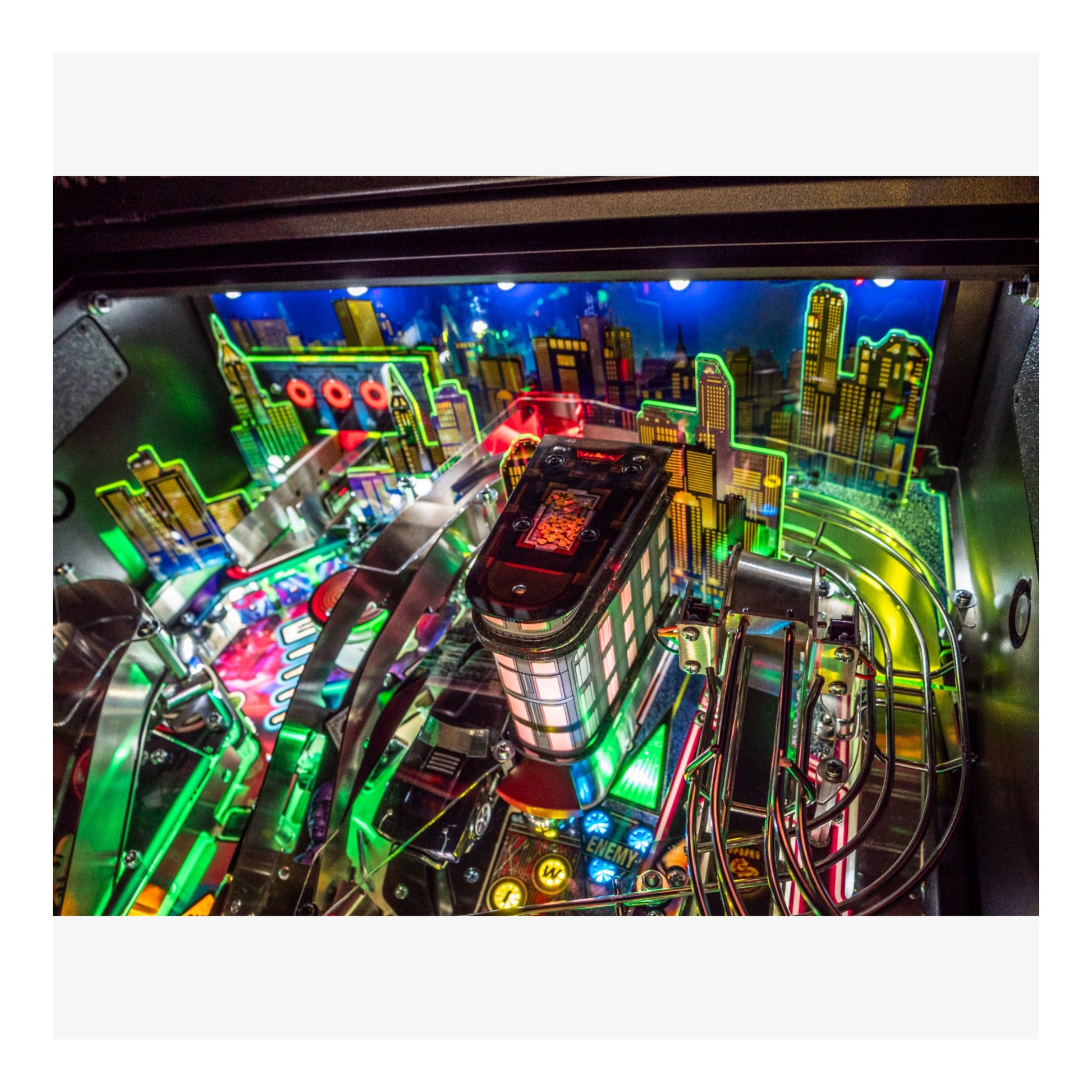 Close-up of a colorful pinball machine with vibrant lights and details.
