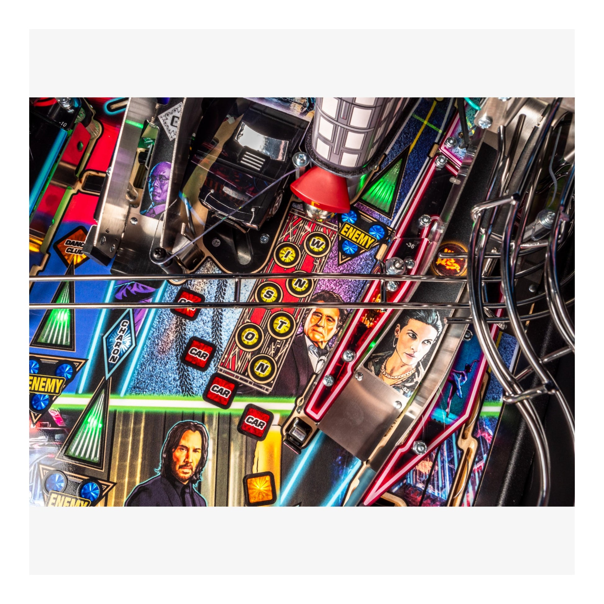 Close-up of a pinball machine with colorful mechanics and character images.