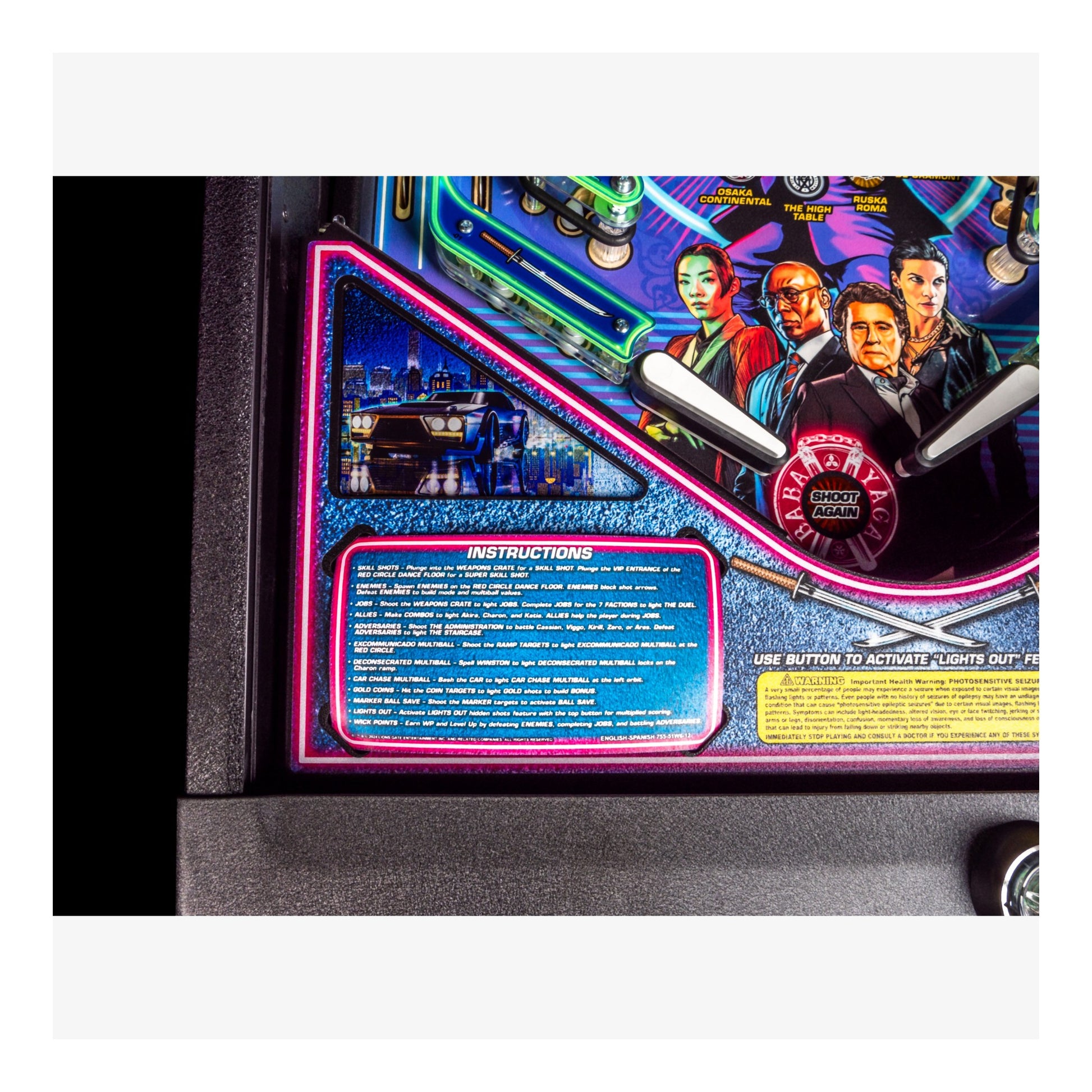 Close-up of a pinball machine with colorful artwork and text on the side.