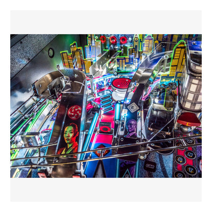 Close-up of a pinball machine with vibrant colors and detailed design.