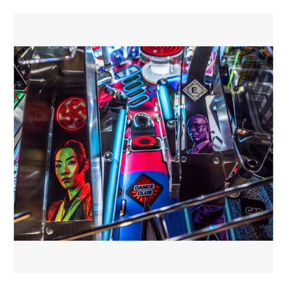 Close-up of a pinball machine with colorful artwork and text.