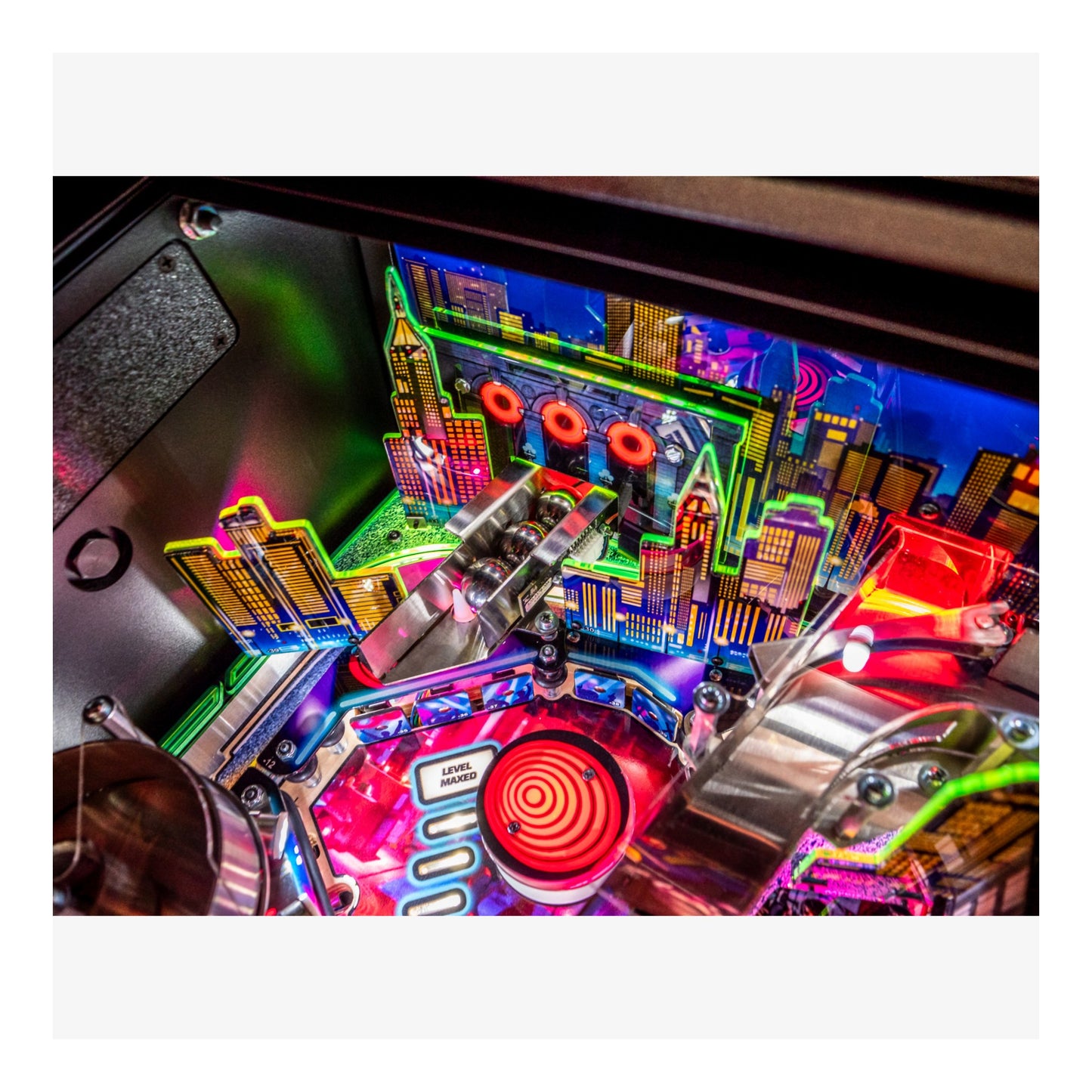 Close-up of a colorful pinball machine with vibrant lights and detailed design.