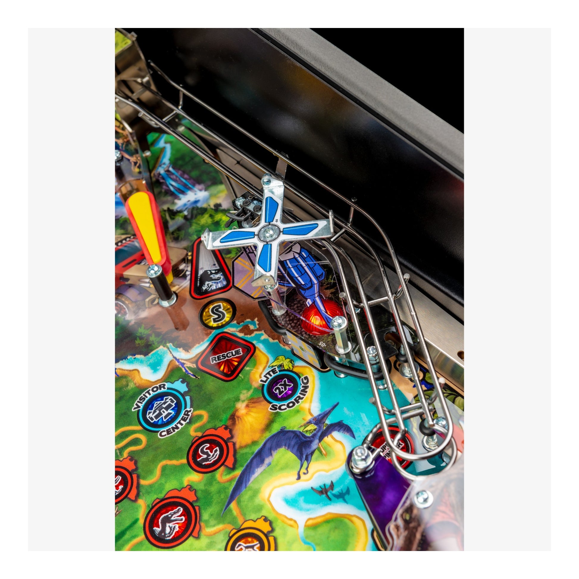 Close-up of a pinball machine with colorful artwork and player controls.