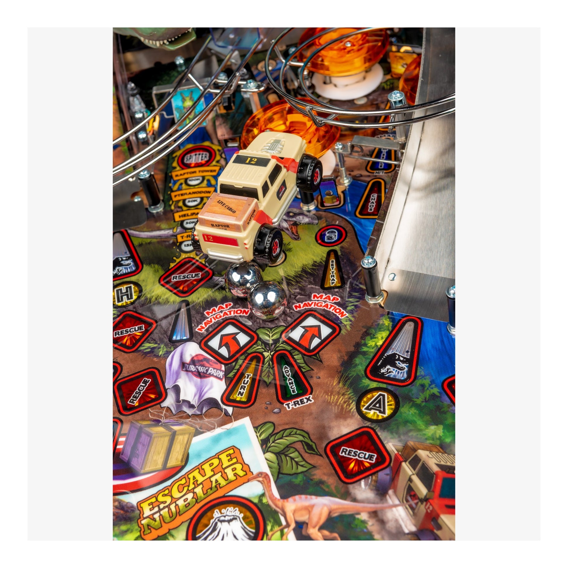 Close-up of a pinball machine with a vehicle and various game elements.