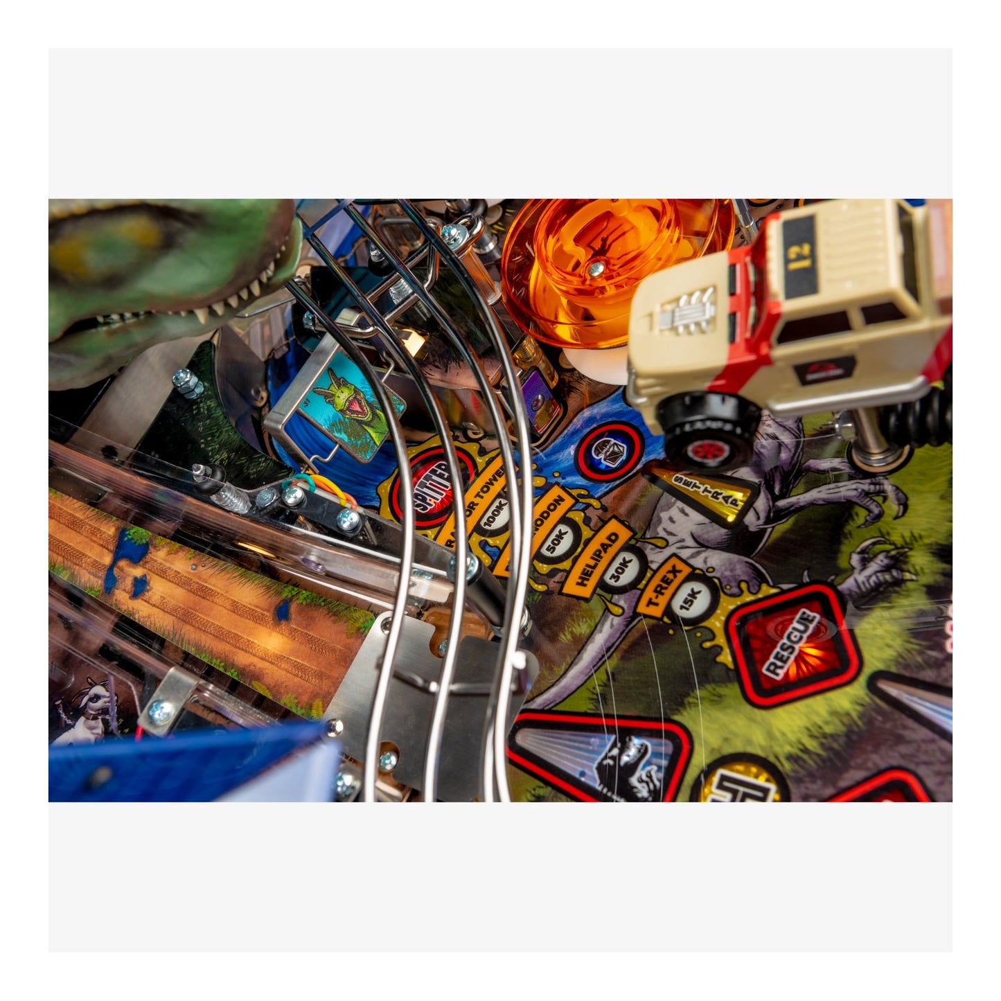 Close-up of a pinball machine with colorful artwork and mechanical components.