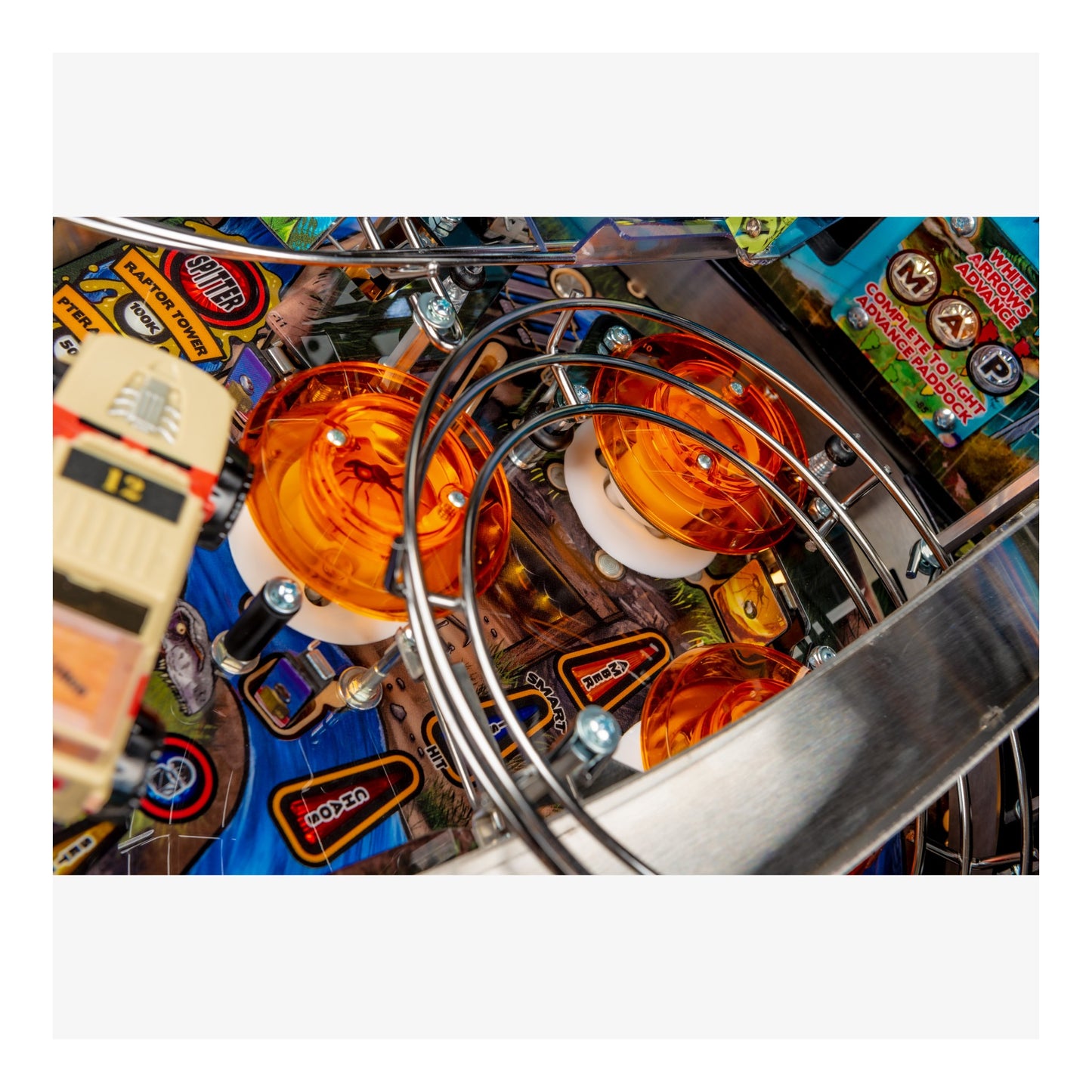 Close-up of a pinball machine with colorful playfield and vintage design elements.