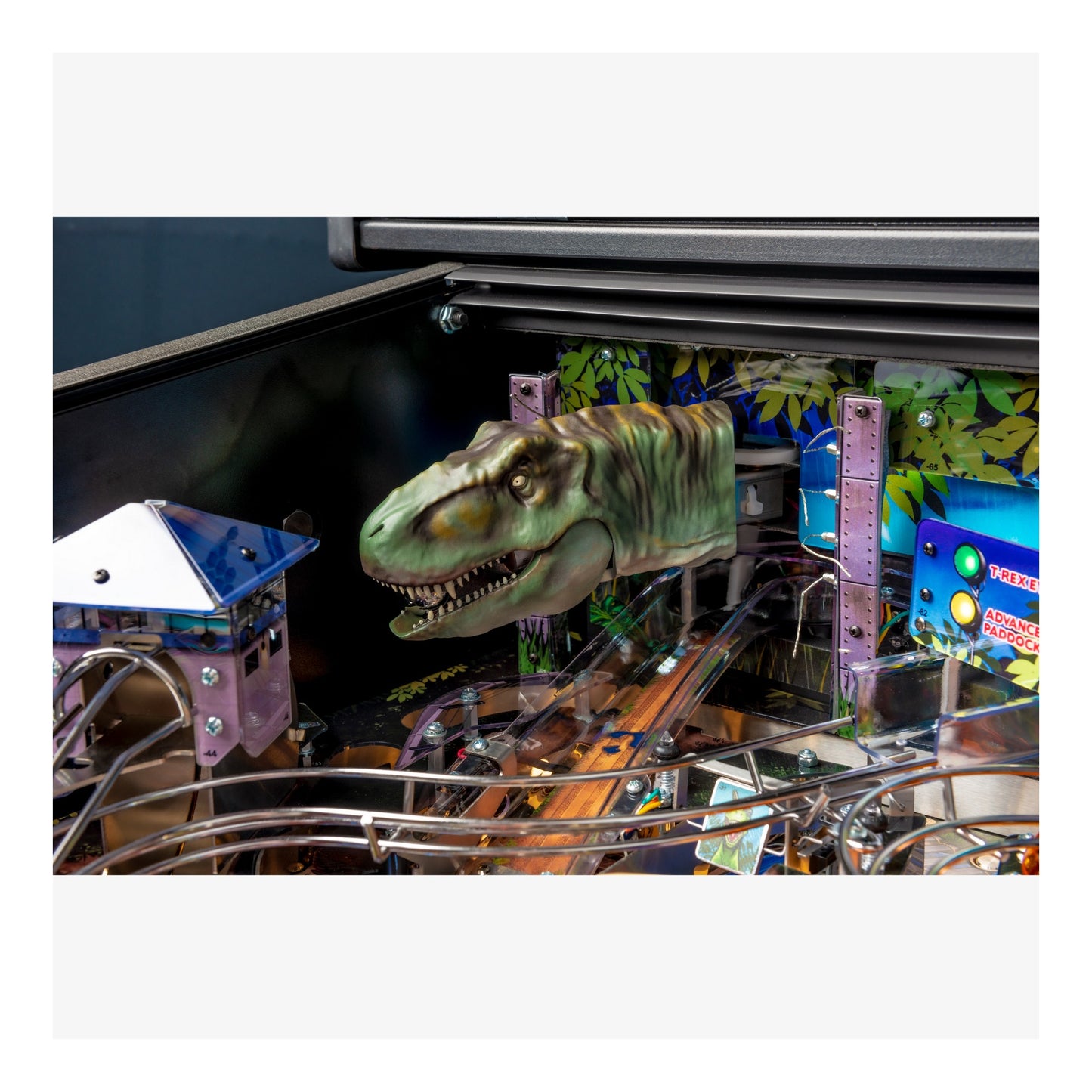 Pinball machine with a dinosaur figure in the playfield