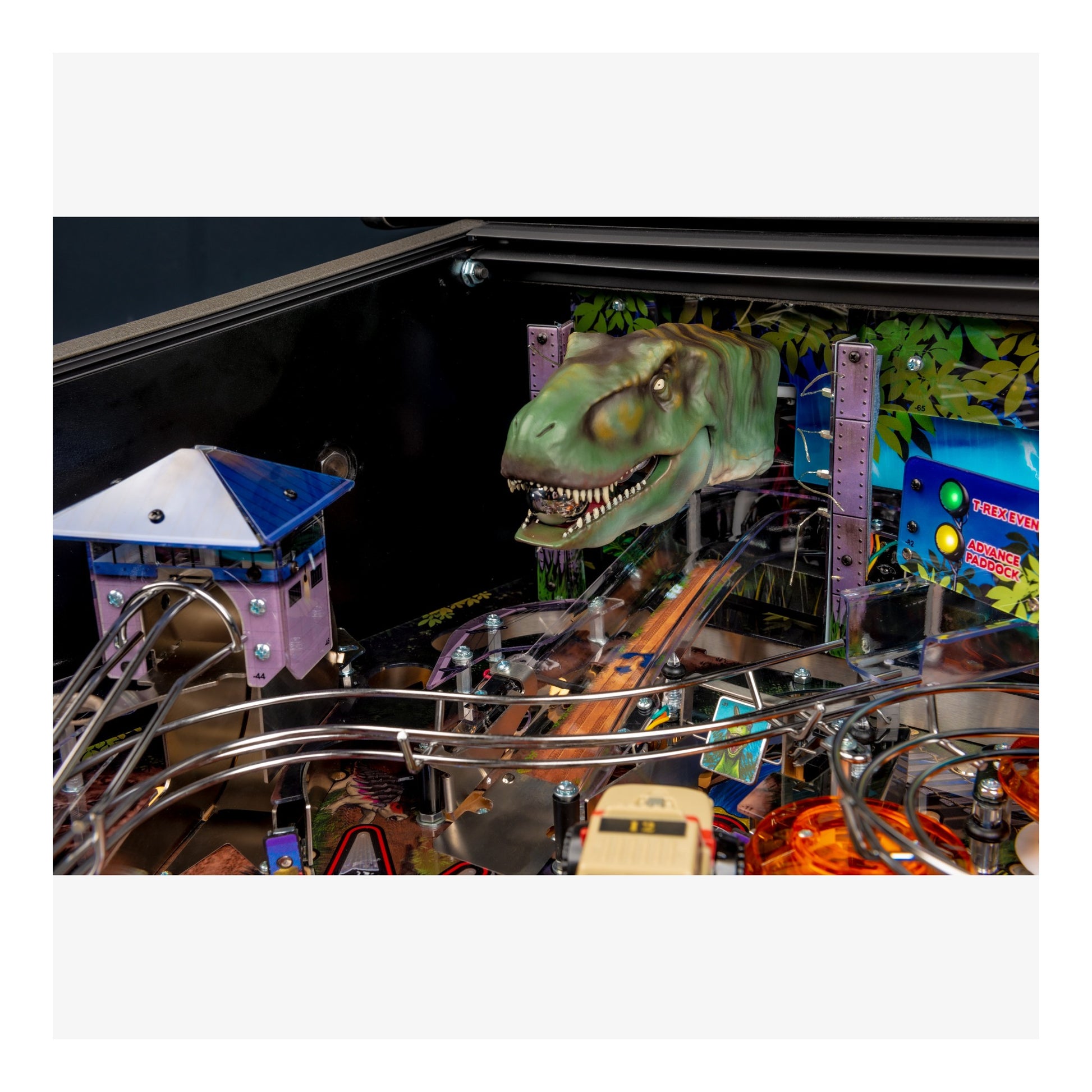 Pinball machine with dinosaur head design on a white background