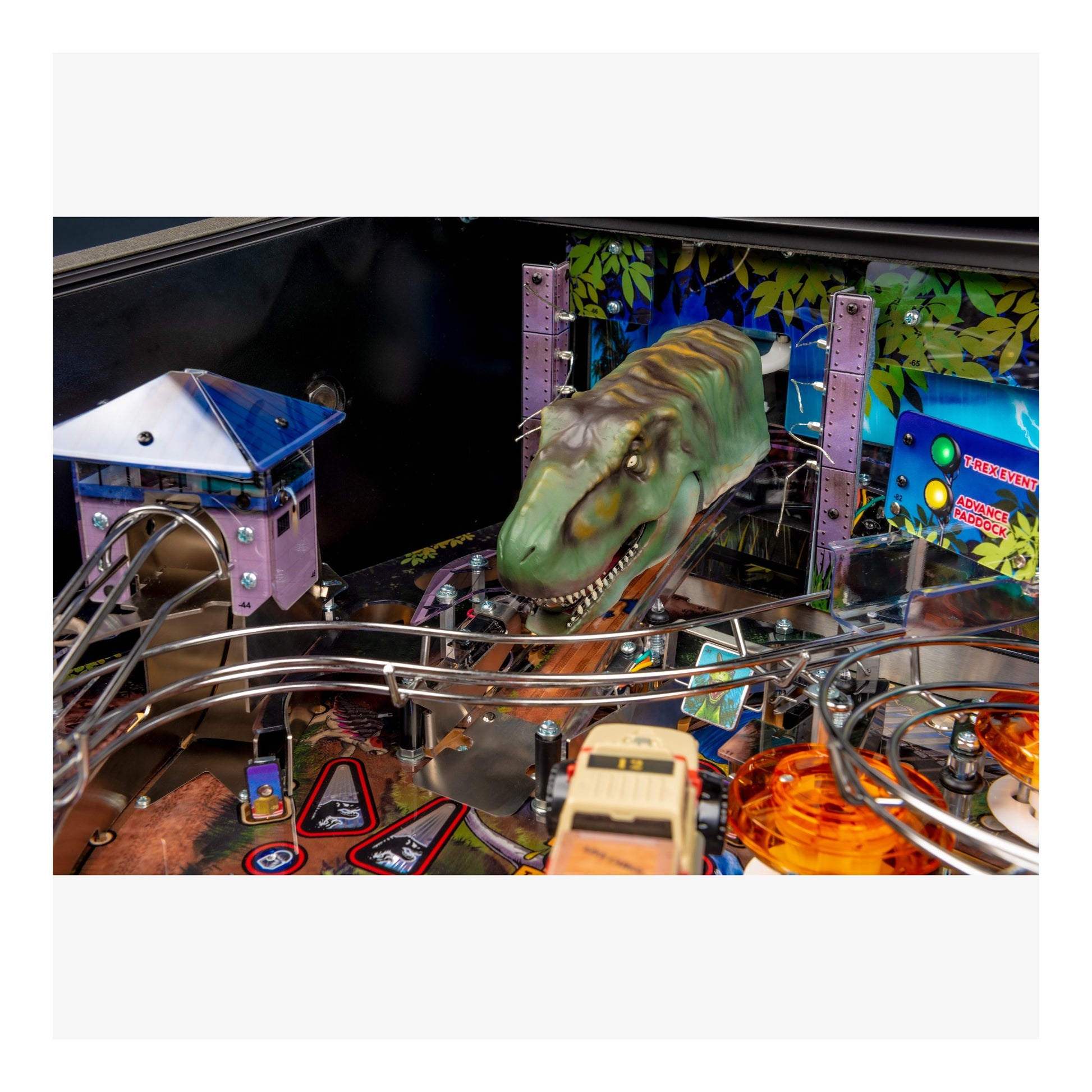 Pinball machine with dinosaur figure and colorful playfield