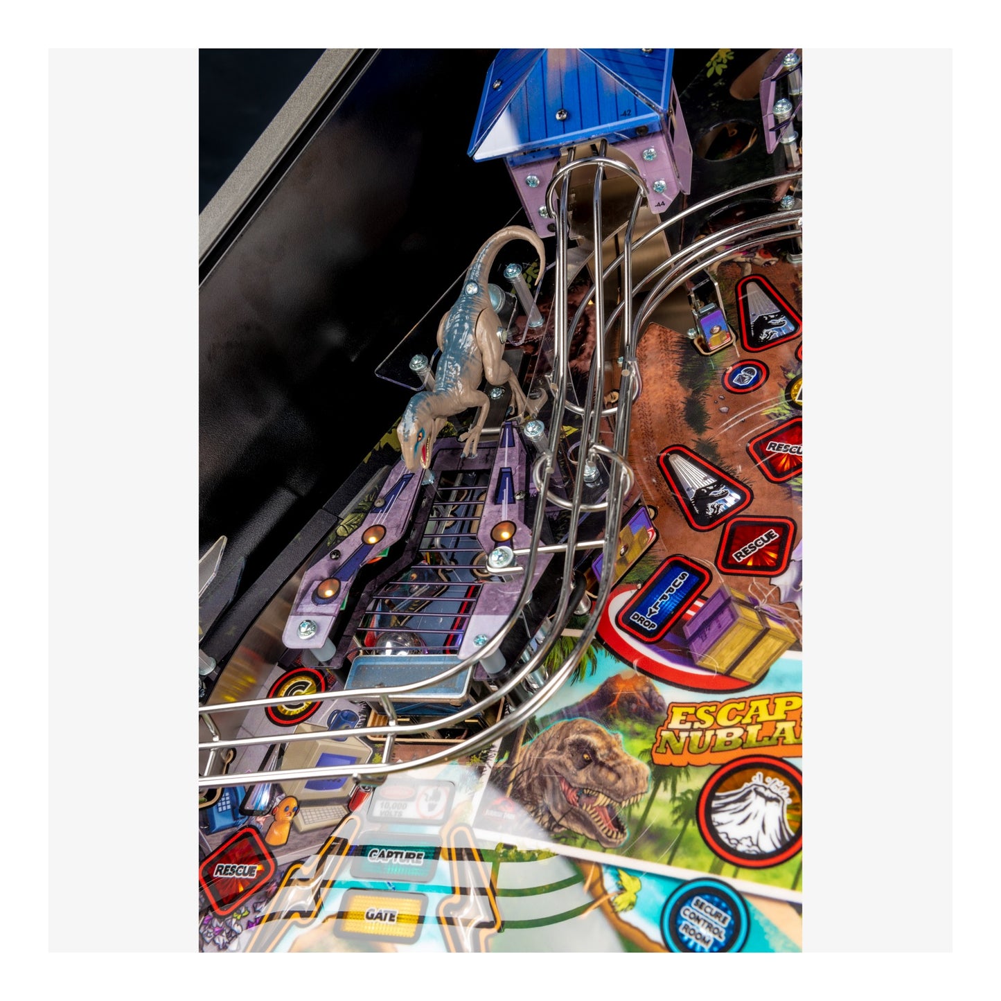 Close-up of a pinball machine with various elements and branding.