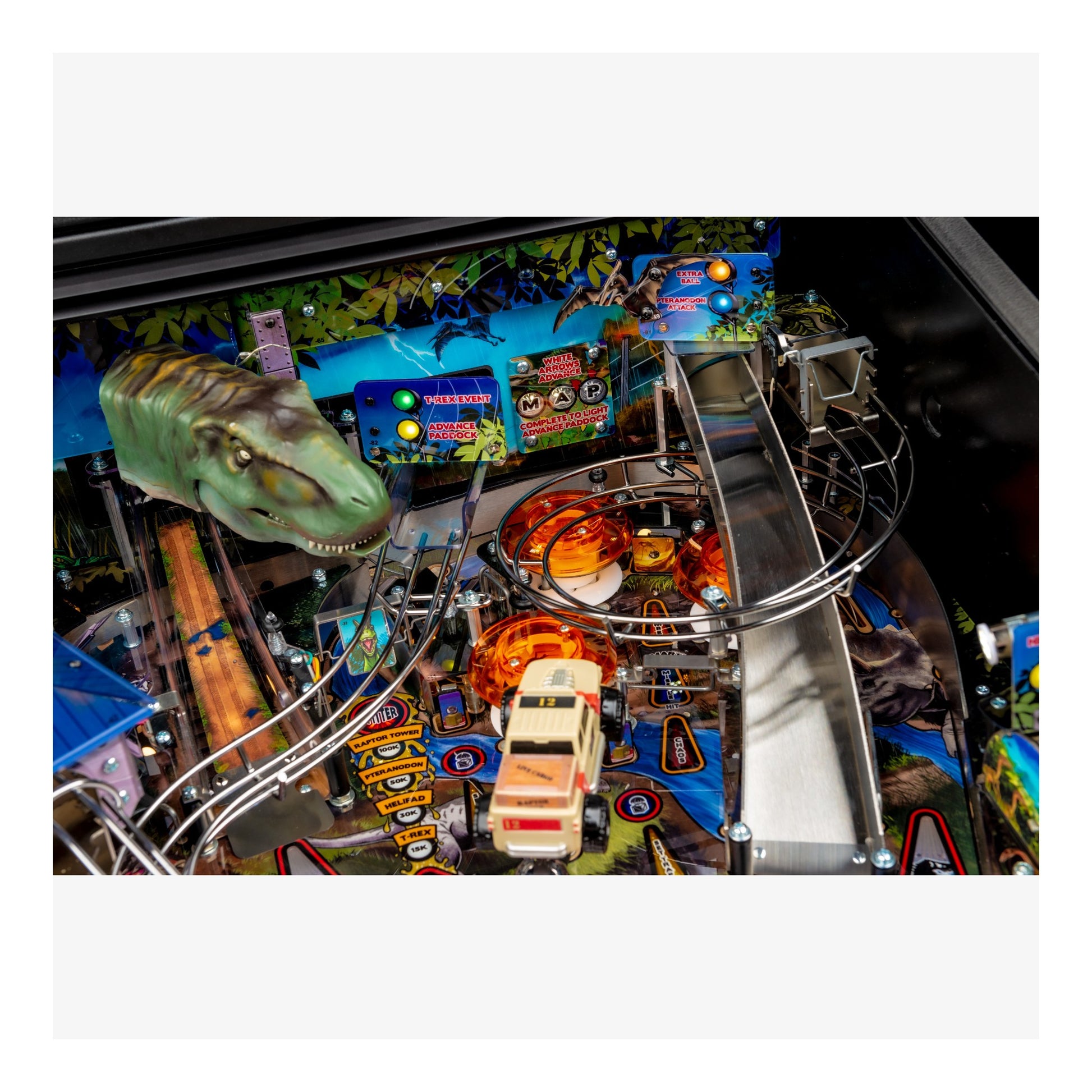 Pinball machine with dinosaur and truck design in an indoor setting