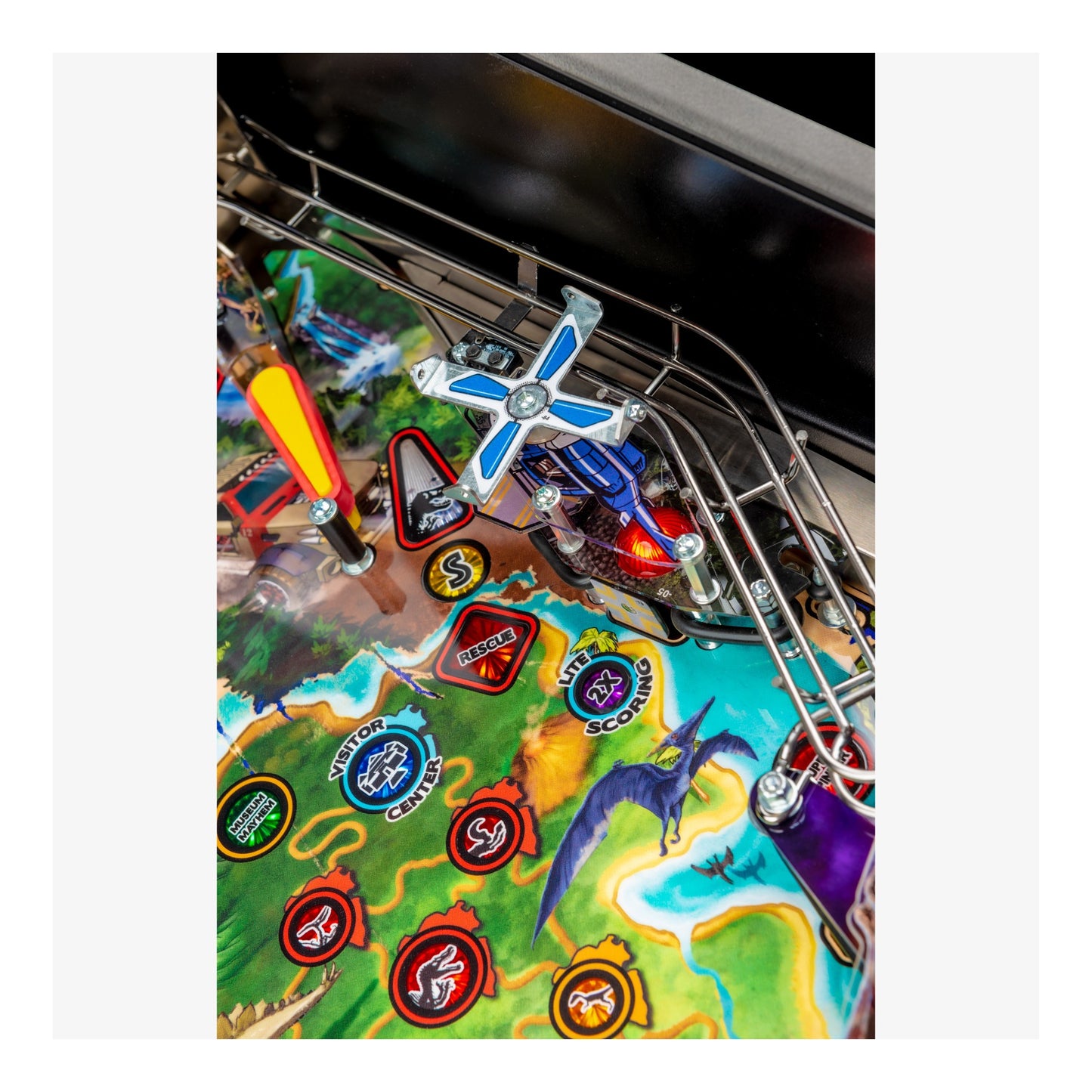 Close-up of a colorful pinball machine with various symbols and graphics.