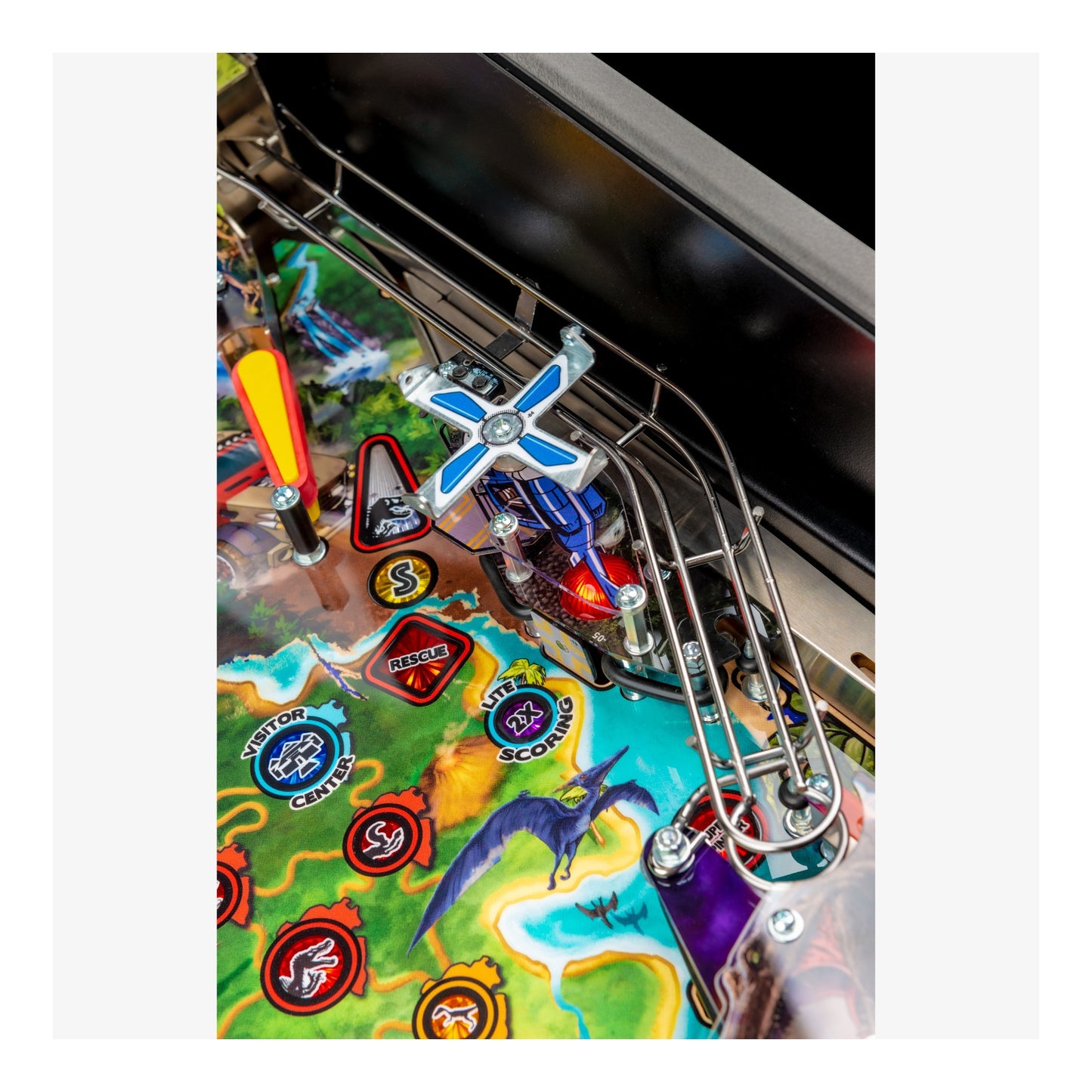 Close-up of a colorful pinball machine with various symbols and designs.