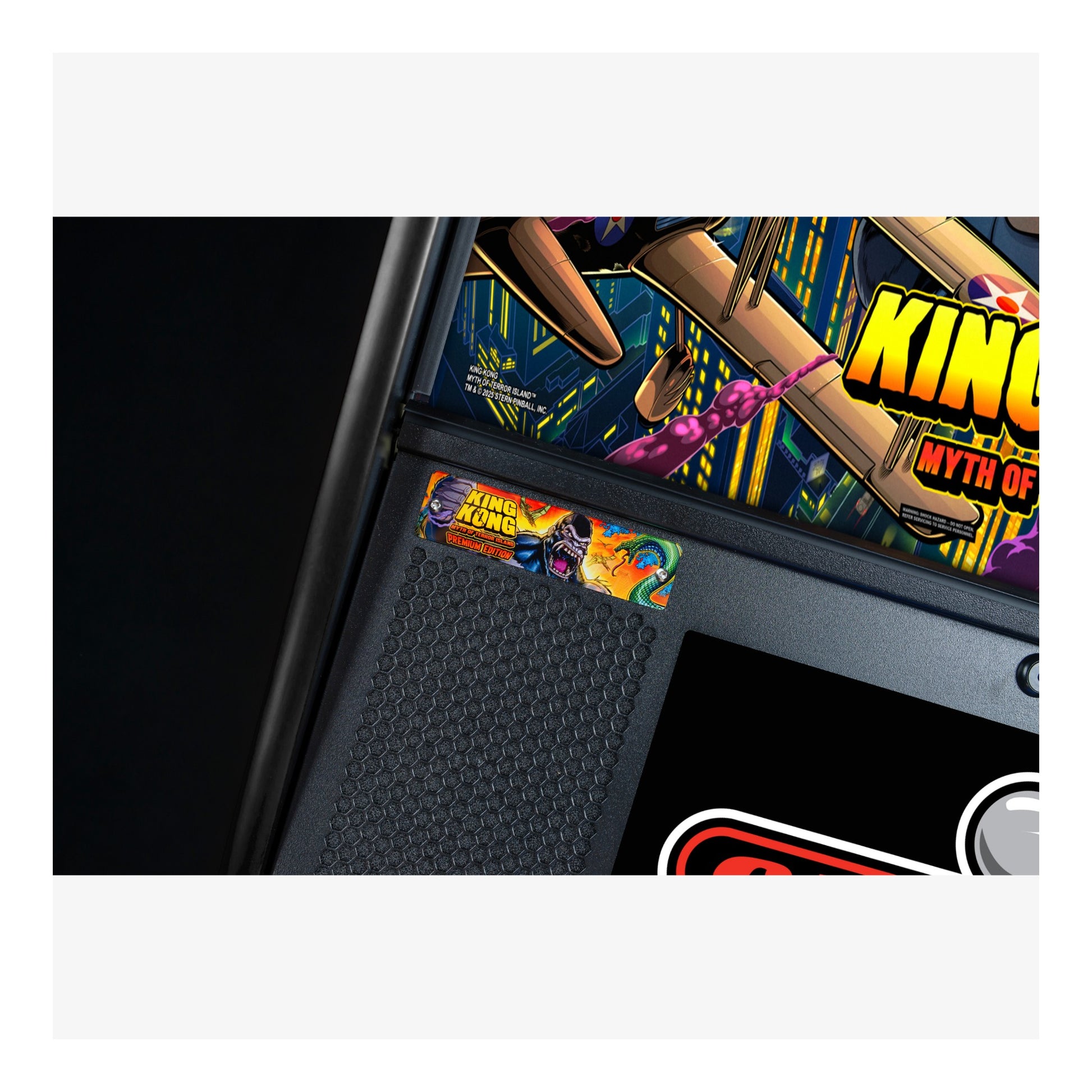 Close-up of a pinball machine with 'King Kong' artwork on the side.