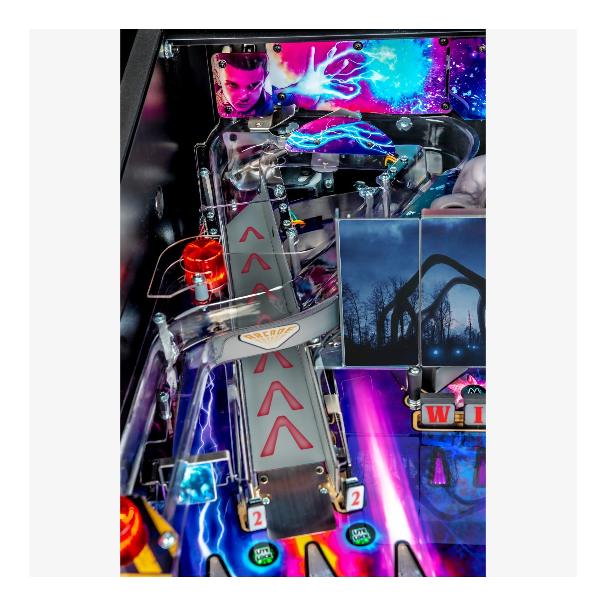Close-up of a colorful pinball machine with vibrant graphics and lights.