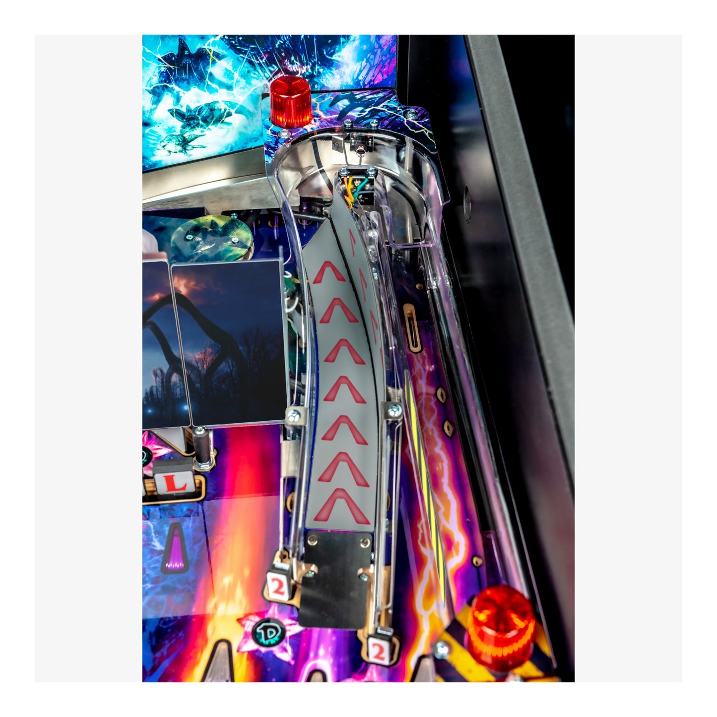 Close-up of a colorful pinball machine with vibrant lights and details.