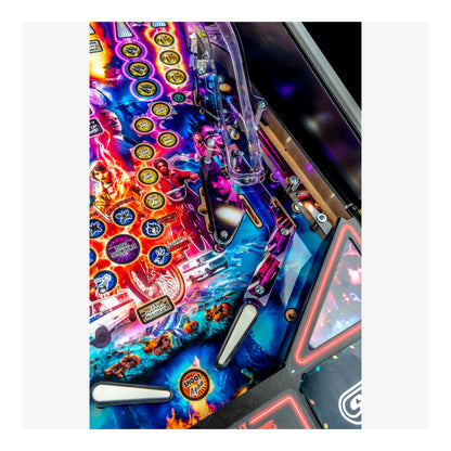 Close-up of a colorful pinball machine with vibrant graphics and bright lights.