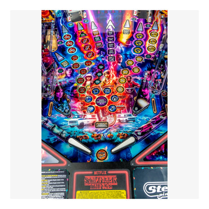 Pinball machine with 'Stranger Things' theme featuring colorful design and characters.