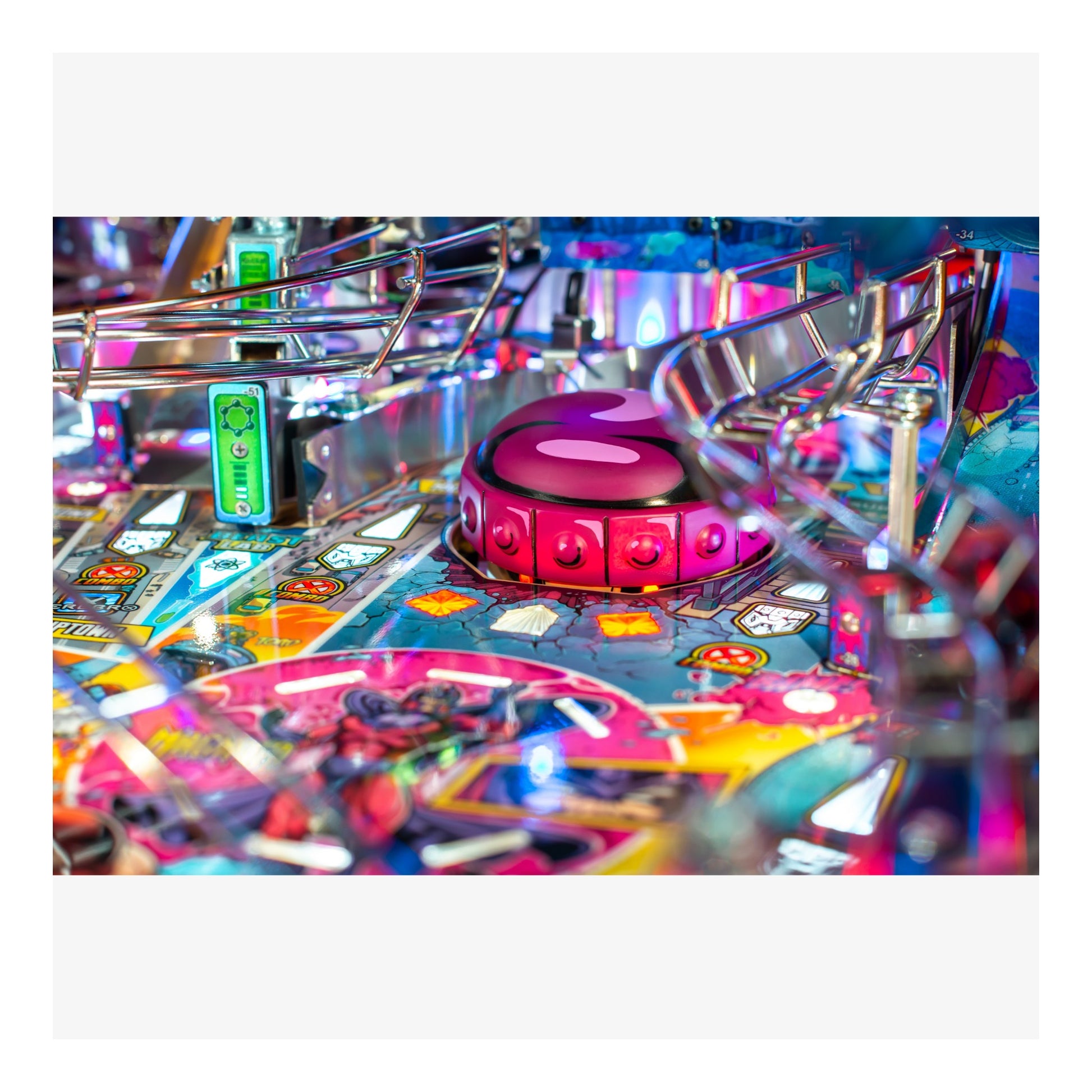 Close-up of a colorful pinball machine with vibrant lights and details.