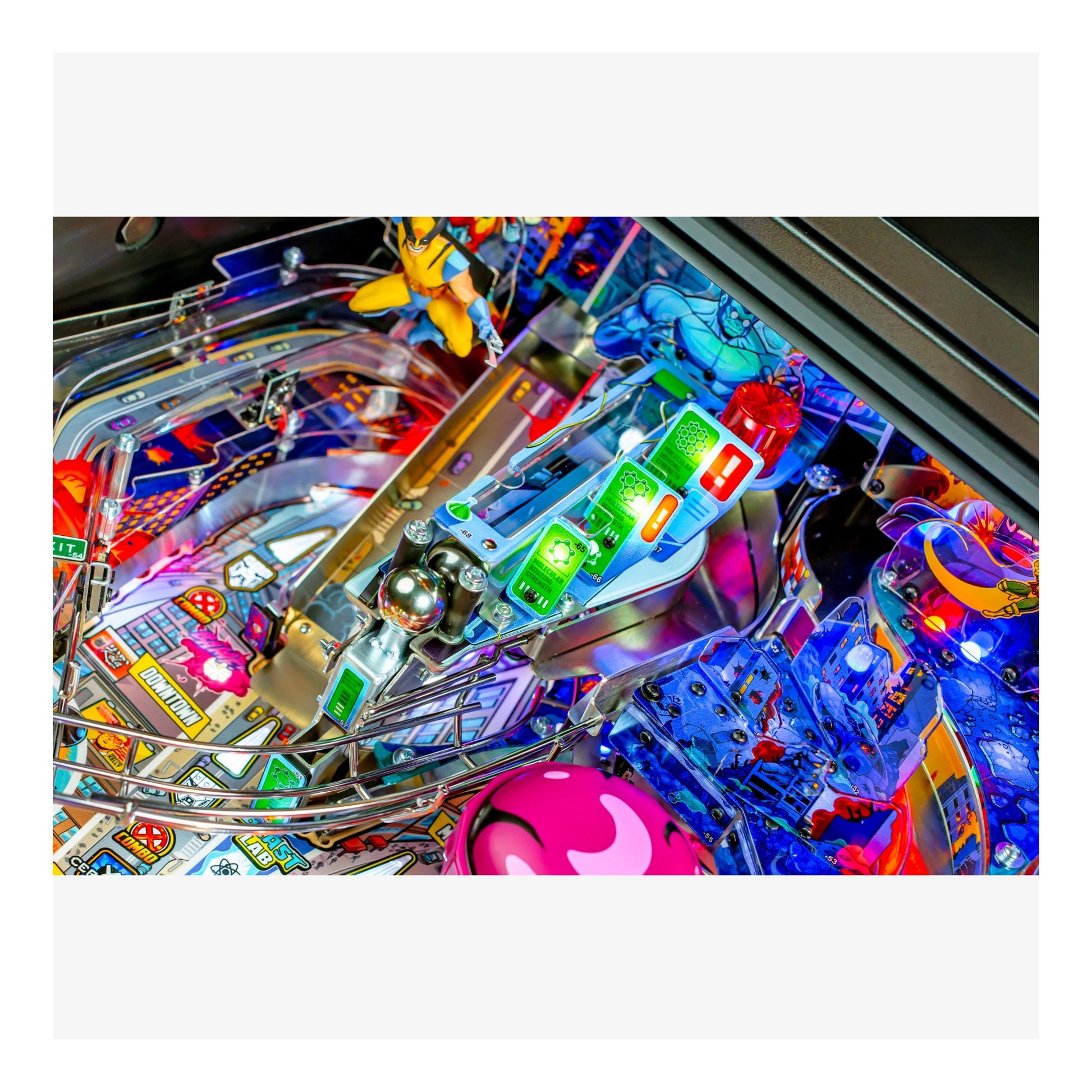 Close-up of a colorful pinball machine with various components and lights.