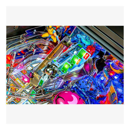 Close-up of a colorful pinball machine with various components and lights.