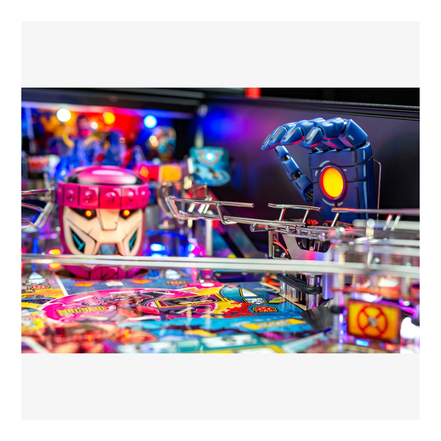 Close-up of a pinball machine with colorful playfield and characters.