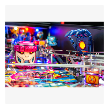 Close-up of a pinball machine with colorful playfield and characters.