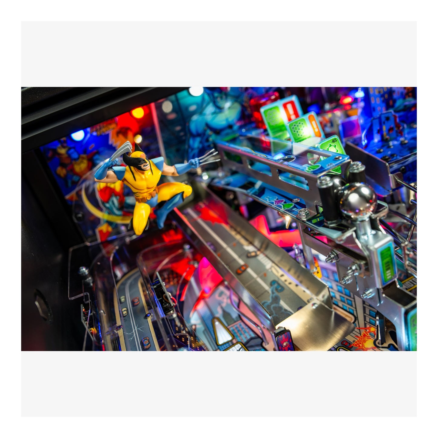 Close-up of a pinball machine with colorful lights and a superhero figure.