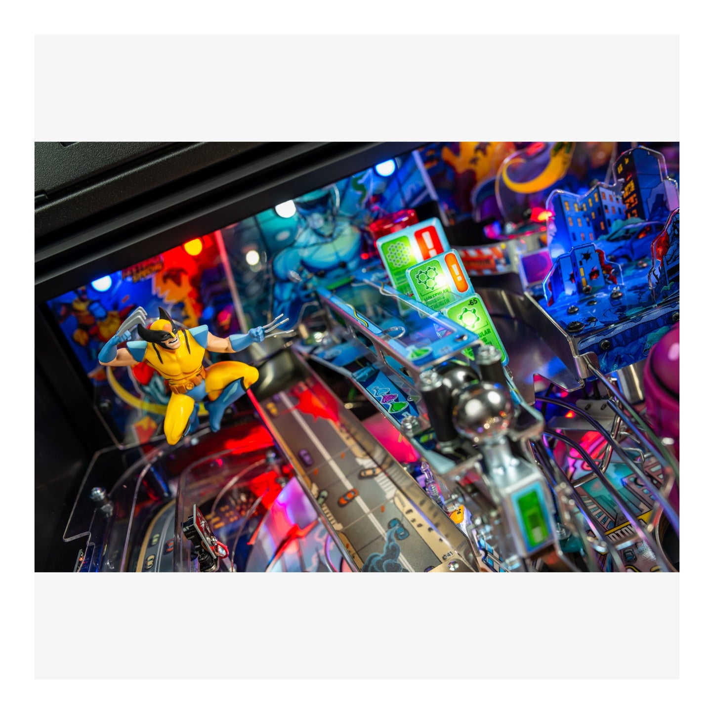 Close-up of a colorful pinball machine with vibrant lights and figures.