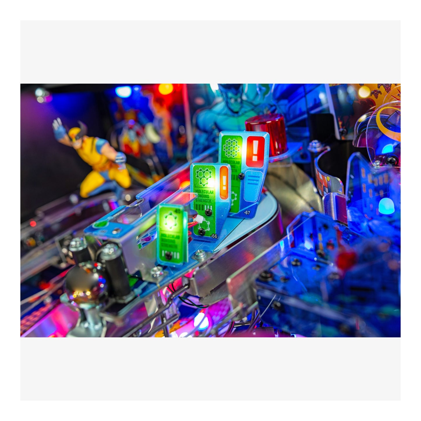 Close-up of a colorful pinball machine with lights and figures.