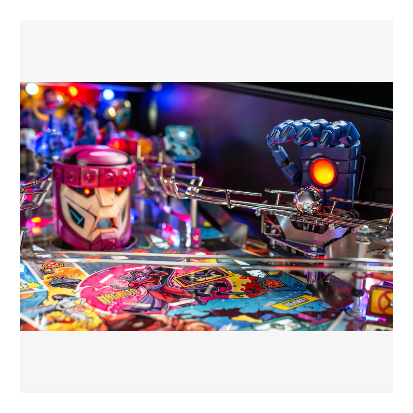 Close-up of a colorful pinball machine with vibrant graphics and bright lights.