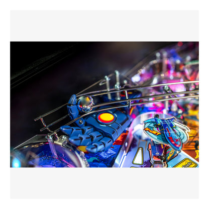 Close-up of a pinball machine with colorful playfield and lights.