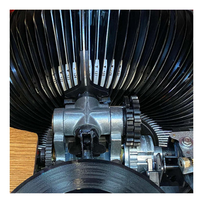 Close-up of a typewriter's type mechanism with moving parts.