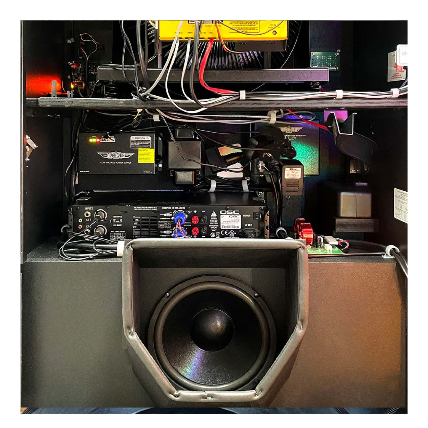 Close-up of audio equipment with a subwoofer in a technical setting