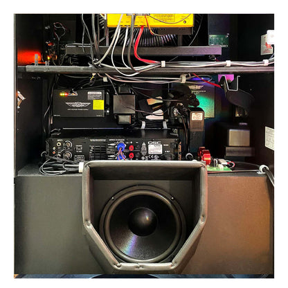 Close-up of audio equipment with a subwoofer in a technical setting