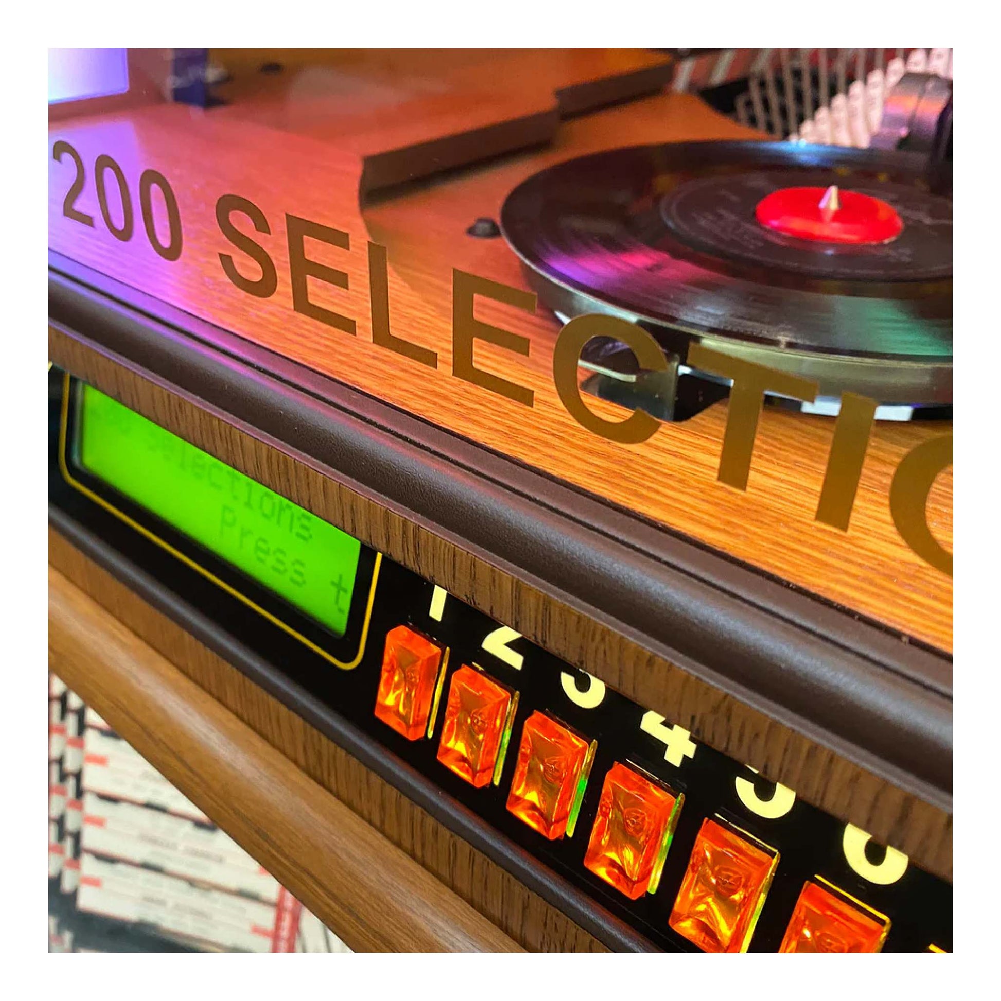 Record player with vinyl record and digital display on a wooden surface.