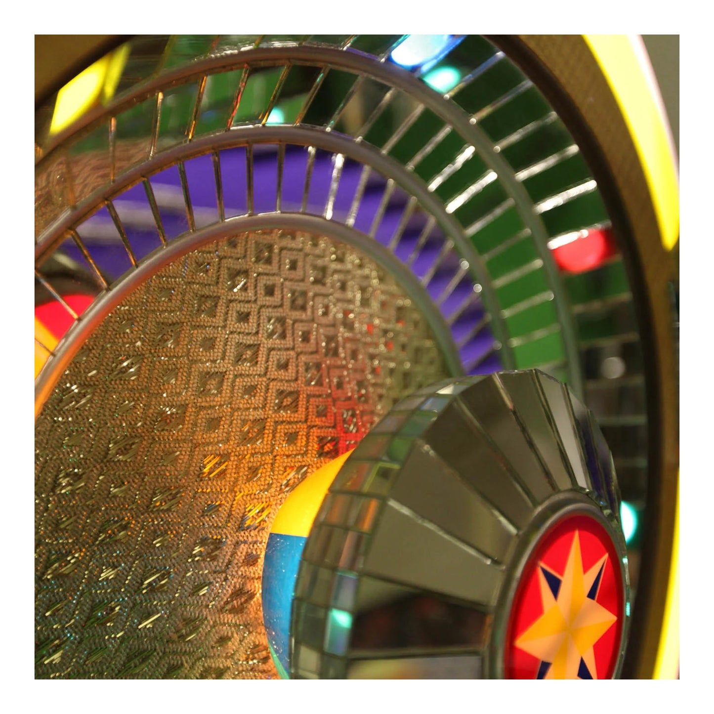 Close-up of a colorful wheel with metallic and reflective surfaces
