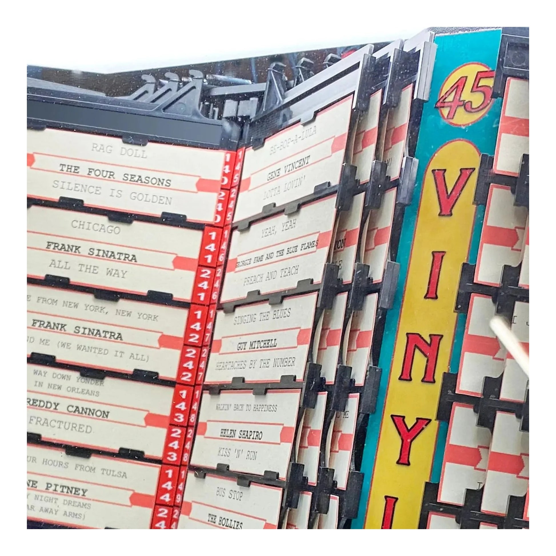 Collection of vinyl records with a prominent 'Vinyl' sign.