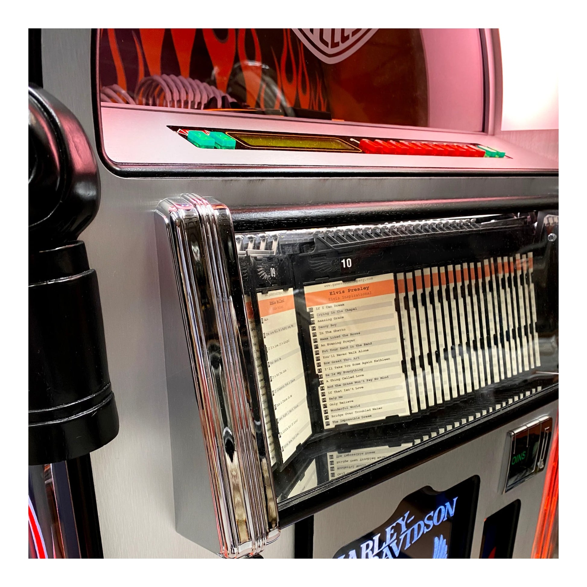 Close-up of a vintage jukebox with a list of songs displayed.
